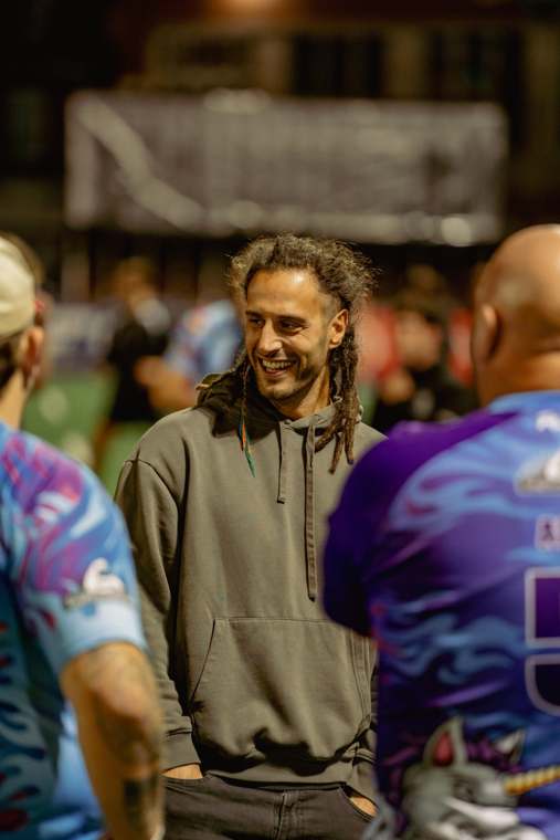 Josh Navidi laughing with players at pitchside